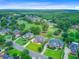 An aerial view of a suburban neighborhood, featuring a golf course and a pond at 4246 Club Course Dr, North Charleston, SC 29420