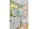 Stylish bathroom featuring a white vanity, tropical wallpaper and updated fixtures at 4246 Club Course Dr, North Charleston, SC 29420