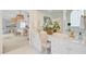 Bright bathroom featuring double sink vanity, soaking tub, and doorway to bedroom with woven pendant lighting at 4246 Club Course Dr, North Charleston, SC 29420