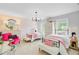 Charming bedroom featuring two beds, pink accents, patterned wallpaper, and a bright pink velvet chair at 4246 Club Course Dr, North Charleston, SC 29420