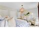 Bedroom with blue bedding, wooden chandelier, dresser, and white chair at 4246 Club Course Dr, North Charleston, SC 29420