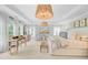 Spacious primary bedroom with decorative light fixtures, neutral colors and many windows at 4246 Club Course Dr, North Charleston, SC 29420