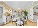 Formal dining room features stylish wallpaper, hardwood flooring, a large dining table, and elegant decor at 4246 Club Course Dr, North Charleston, SC 29420