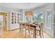 Bright dining room featuring dining table, chairs, built-in cabinet, and large window with backyard view at 4246 Club Course Dr, North Charleston, SC 29420
