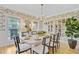 Elegant dining room features stylish wallpaper, light-wood table with seating, and a chic display case at 4246 Club Course Dr, North Charleston, SC 29420