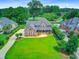 Charming brick two-story home with a well-manicured lawn and a long driveway at 4246 Club Course Dr, North Charleston, SC 29420