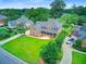 Beautiful brick two-story home featuring a large front yard and mature landscaping at 4246 Club Course Dr, North Charleston, SC 29420