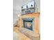 Living room brick fireplace with a wooden mantle and a television with a fountain view at 4246 Club Course Dr, North Charleston, SC 29420