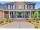 Inviting front porch features brick steps, columns, iron railings, and meticulous landscaping at 4246 Club Course Dr, North Charleston, SC 29420