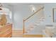 Bright hallway with hardwood floors and staircase with natural light from a round window at 4246 Club Course Dr, North Charleston, SC 29420