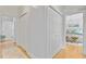 Hallway with two closets, one leading to bedroom with accent pillows on bed at 4246 Club Course Dr, North Charleston, SC 29420