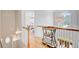 Upstairs hallway with hardwood floors, decorative lighting, and a view into a bedroom at 4246 Club Course Dr, North Charleston, SC 29420