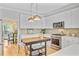 Bright kitchen featuring white cabinets, stainless steel appliances, kitchen island, and modern pendant lighting at 4246 Club Course Dr, North Charleston, SC 29420