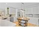 Kitchen featuring white cabinetry, stainless steel appliances, eat-in area, and hardwood floors at 4246 Club Course Dr, North Charleston, SC 29420