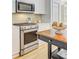 Modern kitchen featuring stainless steel oven, microwave, white cabinetry and hardwood floors at 4246 Club Course Dr, North Charleston, SC 29420