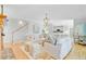 Spacious living room with stairs, white sofas, fireplace in the background, and light-wood floors at 4246 Club Course Dr, North Charleston, SC 29420
