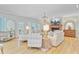 Cozy living room with a fireplace, French doors, light-wood floors and comfortable seating at 4246 Club Course Dr, North Charleston, SC 29420
