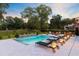 Backyard pool with waterfall, poolside seating, and lounge chairs provide a relaxing outdoor living experience at 4246 Club Course Dr, North Charleston, SC 29420