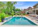 Beautiful pool area with lush landscaping, comfortable seating, and a serene waterfall feature at 4246 Club Course Dr, North Charleston, SC 29420