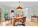 Bright and airy study with light-wood floors, large windows, and a classic wooden desk at 4246 Club Course Dr, North Charleston, SC 29420