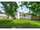 Lush, grassy backyard with a glimpse of the home's exterior showcasing the chimney and roof at 4939 Ashby Ave, North Charleston, SC 29405