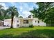 Exterior view of the home showcasing the windows, grill, and lush lawn at 4939 Ashby Ave, North Charleston, SC 29405