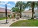 Inviting backyard patio with lounge seating and fire pit, surrounded by lush lawn and mature palm trees at 4939 Ashby Ave, North Charleston, SC 29405