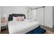 Bright bedroom featuring a comfortable bed and ensuite bathroom with barn door at 4939 Ashby Ave, North Charleston, SC 29405