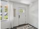 Bright entryway featuring a white front door, a window with sheer curtains, and a stylish rug at 4939 Ashby Ave, North Charleston, SC 29405