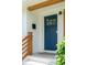 Close-up of a blue front door with glass panes, complemented by a brick facade and wooden accents at 4939 Ashby Ave, North Charleston, SC 29405