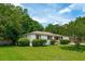 Charming home with a well-manicured lawn, complemented by lush greenery and blossoming bushes at 4939 Ashby Ave, North Charleston, SC 29405