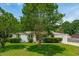 Well-maintained home with a lush front lawn, complemented by mature trees and meticulously trimmed shrubbery at 4939 Ashby Ave, North Charleston, SC 29405