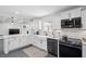 Well-lit kitchen with modern appliances and fixtures, marble countertops, and ample cabinet space at 4939 Ashby Ave, North Charleston, SC 29405