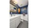 Well-lit bathroom featuring a modern vanity, ornate mirror, toilet, and blue walls with white trim at 507 Stinson Dr # B3, Charleston, SC 29407