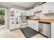 Bright kitchen featuring white cabinets, wood countertop, stainless appliances, and backyard access at 507 Stinson Dr # B3, Charleston, SC 29407