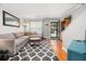 Bright living room with a gray sectional couch, wood floors, and front door view at 507 Stinson Dr # B3, Charleston, SC 29407