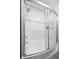White tiled shower featuring a curved glass door and chrome fixtures at 507 Stinson Dr # B3, Charleston, SC 29407