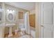 A full bathroom featuring tan tile flooring, a pedestal sink, a toilet, and a shower with a shower curtain at 516 Arlington Dr # B4, Charleston, SC 29414