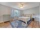 Charming bedroom featuring hardwood floors, a ceiling fan, a large window, and blue accents at 516 Arlington Dr # B4, Charleston, SC 29414