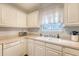 A kitchen area featuring a double basin sink, white cabinets, and a white dishwasher below the counter at 516 Arlington Dr # B4, Charleston, SC 29414