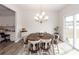 Bright dining room with a rustic wood table and a sliding glass door to the yard at 519 Purple Finch Rd, Summerville, SC 29486