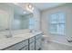 Modern bathroom with dual sinks, a large mirror, and a window for ample natural light at 523 Purple Finch Rd, Summerville, SC 29486