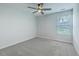 Bright bedroom with a ceiling fan and a large window overlooking a lush green lawn at 523 Purple Finch Rd, Summerville, SC 29486