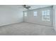 A bright and airy bedroom features neutral paint, carpeted floors and lots of natural light at 523 Purple Finch Rd, Summerville, SC 29486
