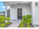 Inviting entryway with a stylish black front door, decorative plants, and house number 523 at 523 Purple Finch Rd, Summerville, SC 29486