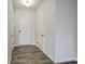Bright hallway with hardwood floors, white walls, and multiple doors leading to other rooms at 523 Purple Finch Rd, Summerville, SC 29486