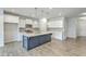 Modern kitchen featuring a central island, white cabinets, stainless steel appliances, and stylish pendant lighting at 523 Purple Finch Rd, Summerville, SC 29486
