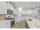 Gourmet kitchen equipped with stainless steel appliances, quartz countertops, a stylish backsplash, and a large island at 523 Purple Finch Rd, Summerville, SC 29486