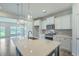 Bright kitchen with an oversized island, white countertops, stainless steel appliances, and pendant lights at 523 Purple Finch Rd, Summerville, SC 29486
