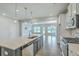 Modern kitchen showcasing a kitchen island with bar seating, stainless steel appliances, and decorative pendant lighting at 523 Purple Finch Rd, Summerville, SC 29486